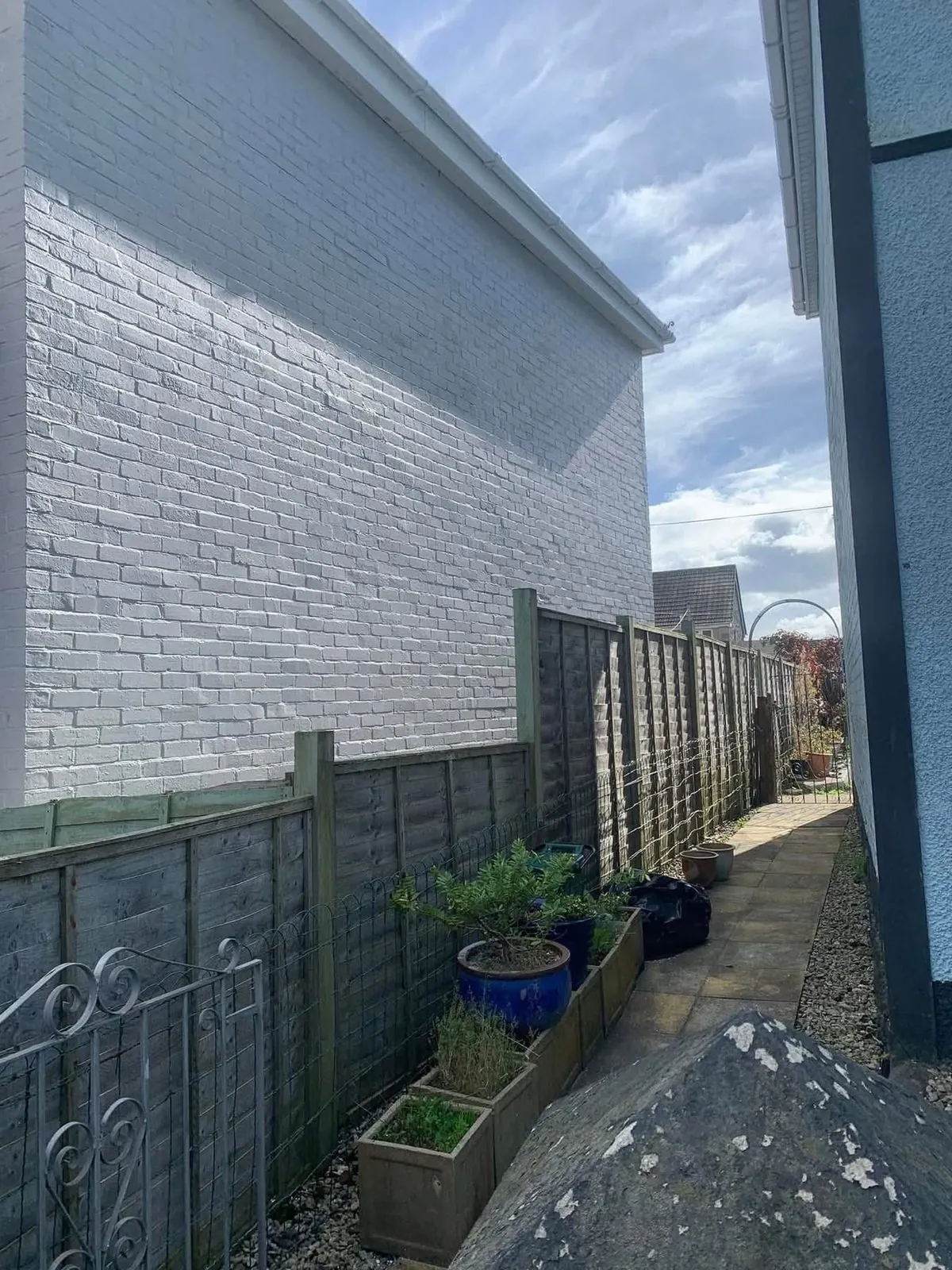 Freshly painted brick wall after preparation and masonry paint in St Stephen in Brannel